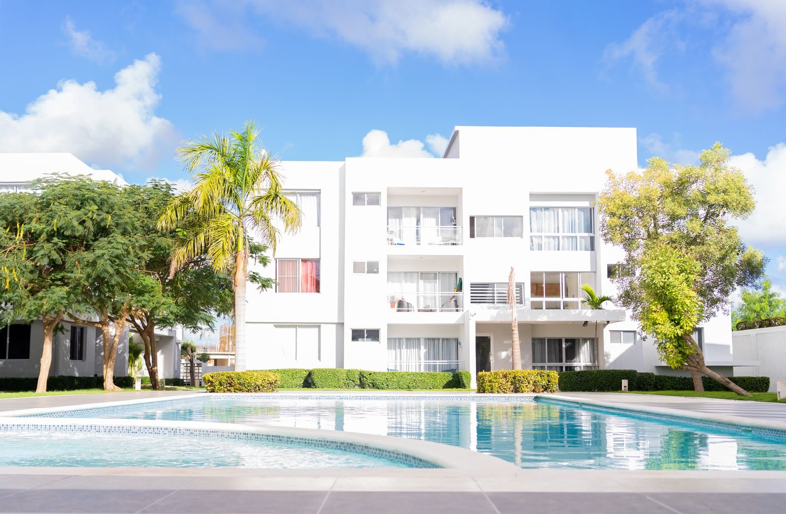 A garden-style apartment community with pool and landscaped grounds